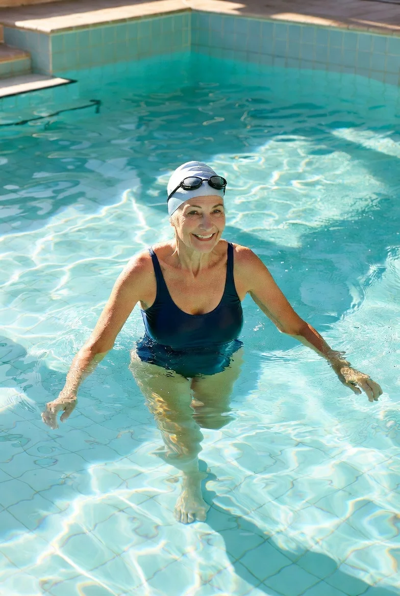 Senior water walking in chest-deep pool for low-impact exercise